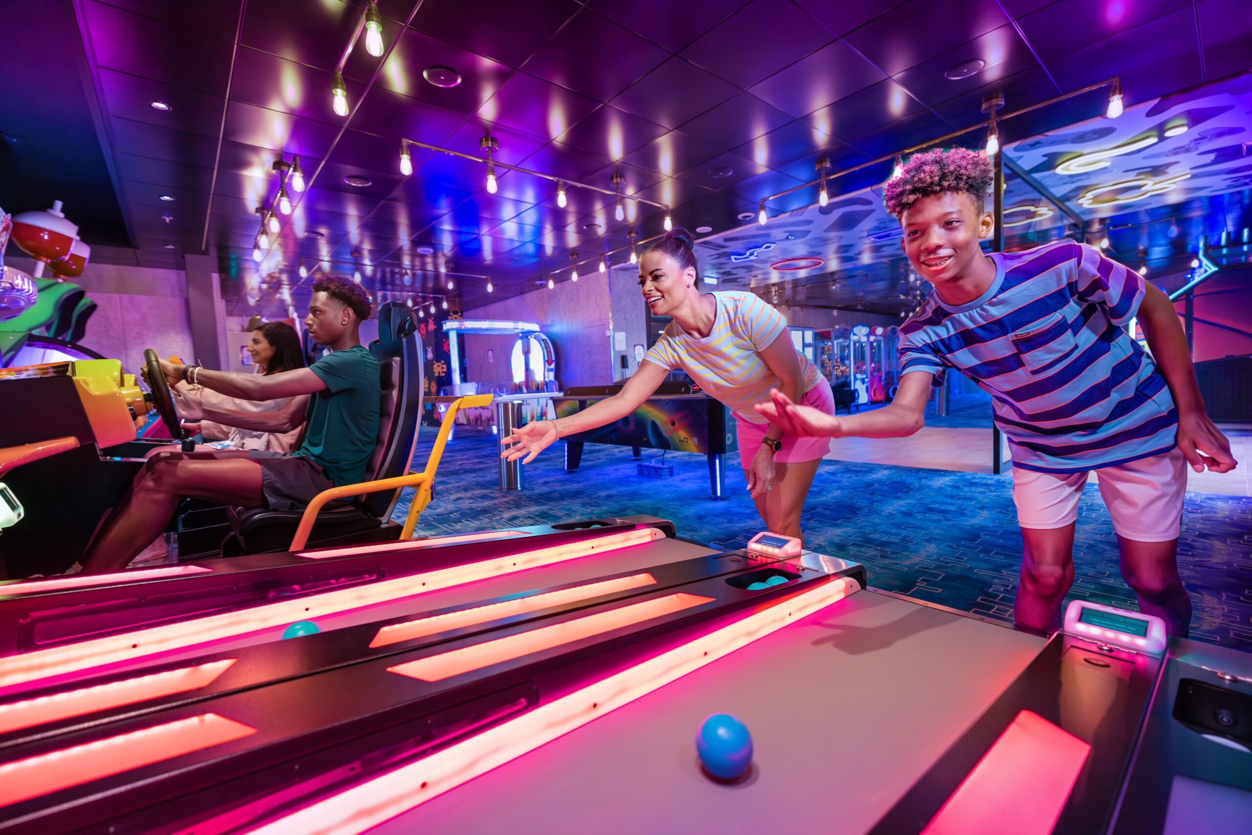 WN, Wonder of the Seas, Mother and son playing skee-ball at the arcade, family fun, games, teens, mom,