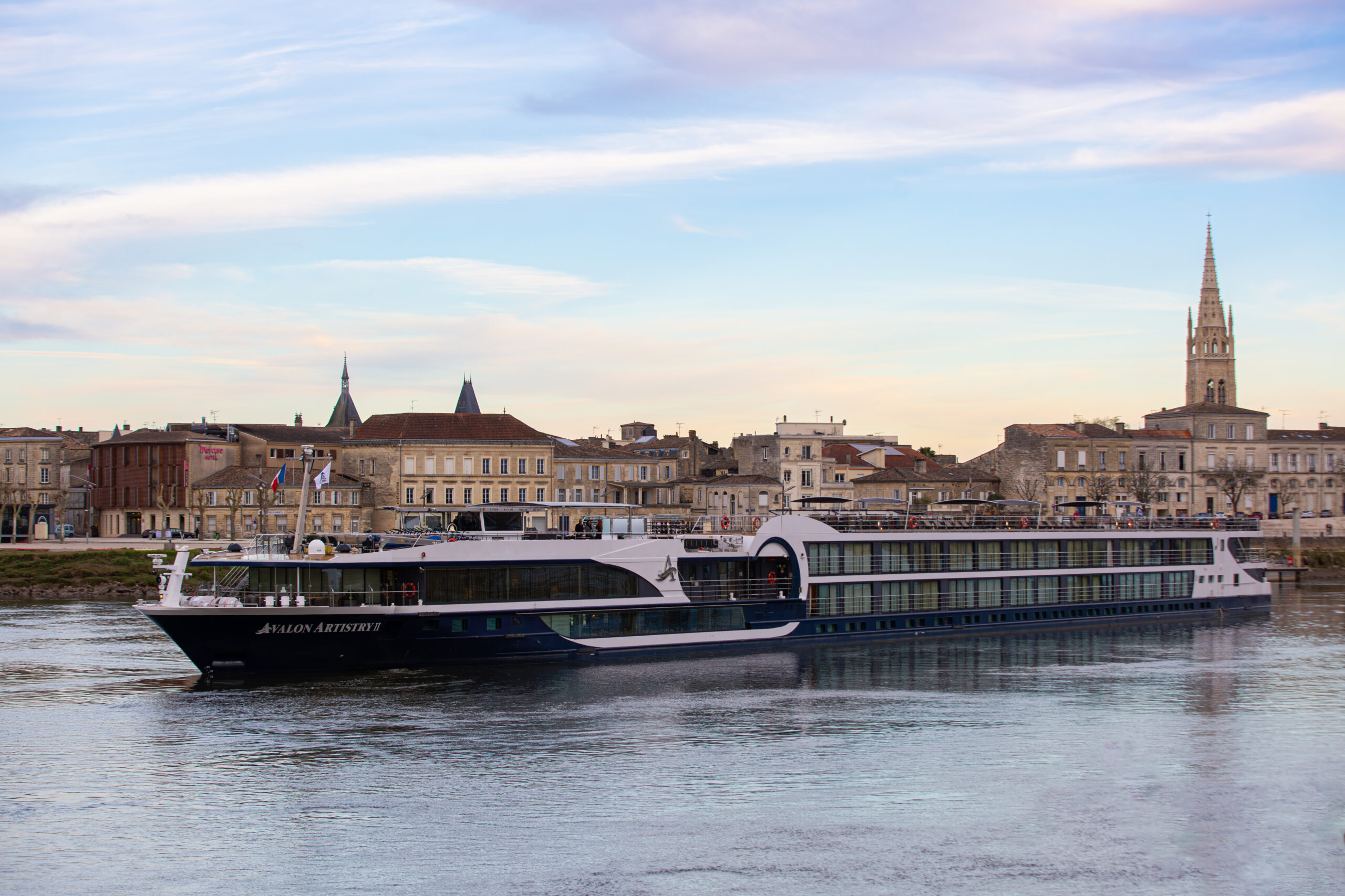 Exterior ArtistryII3 Best luxury river cruise Europe docking in a historic town center.