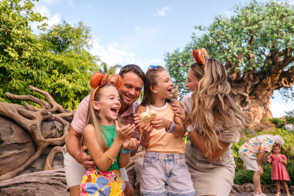 WDW_FY26_CKS_DAK photo of a happy family in front of the tree of life at disney's animal kingdom